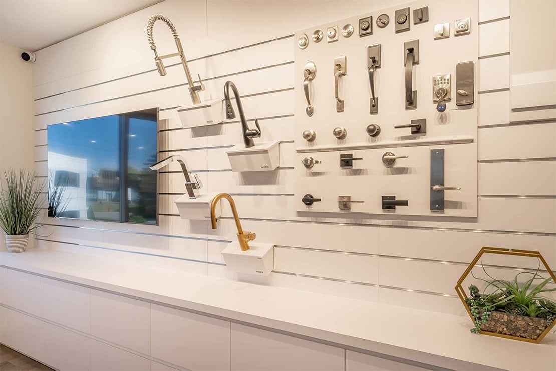 A display of faucets, handles and cabinet hardware.