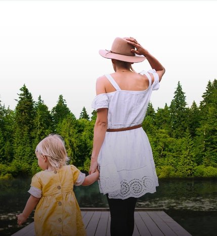 A woman and child beside a lake.